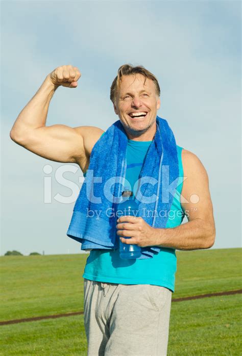 Happy Man Flexing His Bicep Stock Photo Royalty Free Freeimages