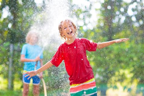 Kids Play With Water Sprinkle Hose Summer Garden Stock Image Image