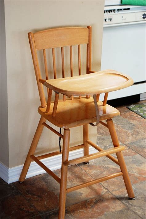 A Wooden High Chair Sitting On Top Of A Kitchen Floor