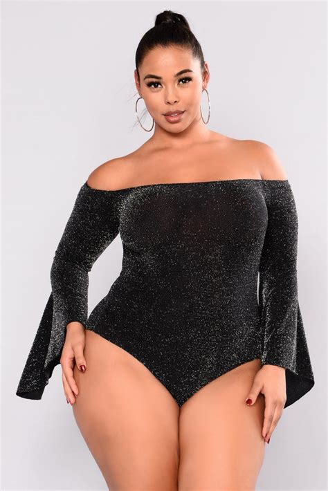 A Woman Wearing A Black Bodysuit With Long Sleeves And High Waist Posing For The Camera