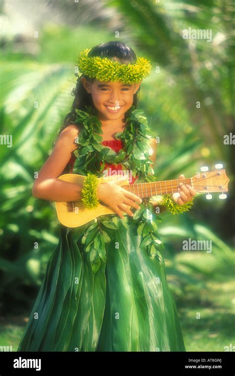Young Hawaiian Girl Age 7 Playing Ukulele Wearing Ti Leaf Skirt And
