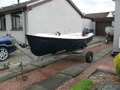 Small Fishing Boat With 4hp Yamaha Four Stroke On Tilt Back Road