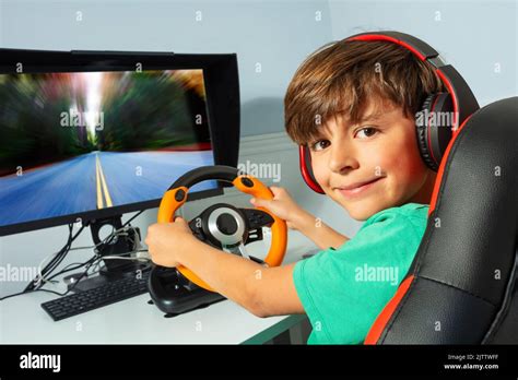 Smiling Gamer Teen Boy Hands On Steering Wheel Play Race Game Stock
