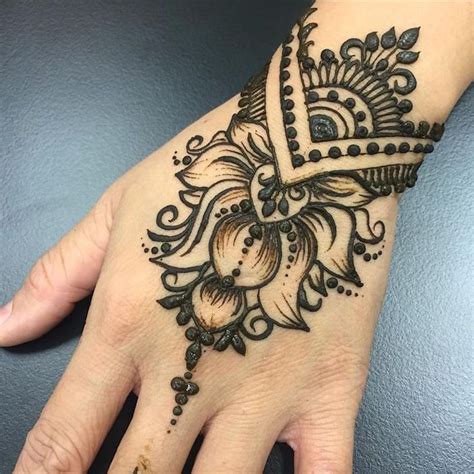 Extreme Close Up Of A Persons Wrist Freshly Decorated With Dark Henna