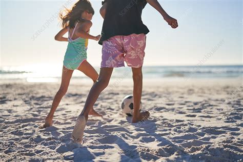 Brother And Sister Playing Soccer On Sunny Beach Stock Image F032