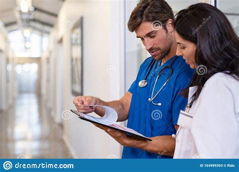 Doctor And Nurse Discussing Medical Report At Clinic Stock Image Image Of Meeting Discussion