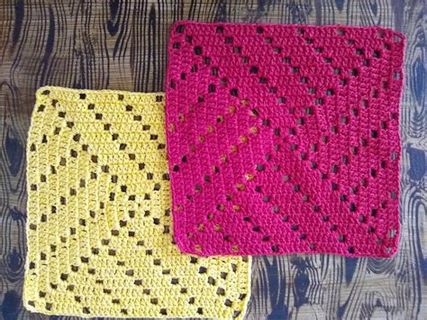 Two Crocheted Squares Sitting Next To Each Other