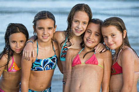 Hispanic Girls In Bikinis Posing On Beach Stock Photo Dissolve