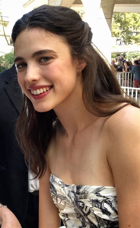 A Woman In A Strapless Dress Smiles At The Camera
