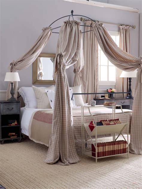 A Wrought Iron Canopy Bed With Gingham Hangings Creates A Cool Country