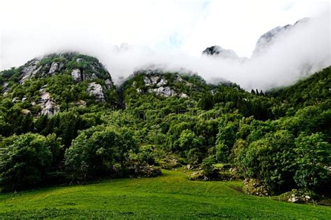 Green Mountain Range In Norway Covered With Mist Fog And Clouds At