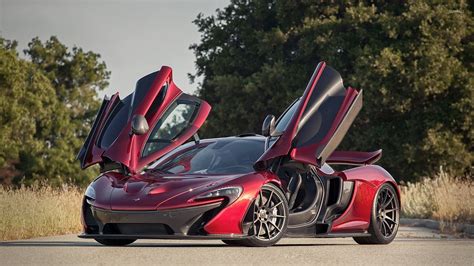 Front Side View Of A Red Mclaren P1 With Opened Door Wallpaper Car