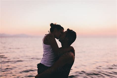 Couple On The Beach Kissing At Sunset By Stocksy Contributor Victor Torres Stocksy