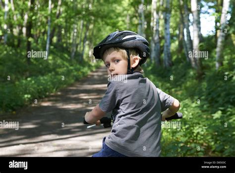 Child Blond Boy 6 7 Years Old Riding Bicycle With Safety Helmet In