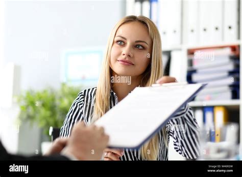 Beautiful Smiling Female Real Estate Agent Offering Male Visitor
