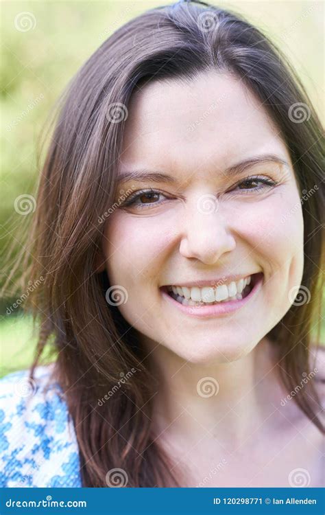 Outdoor Head And Shoulders Portrait Of Laughing Young Woman Stock Image