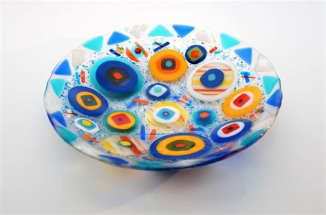 A Colorful Glass Bowl Sitting On Top Of A Table