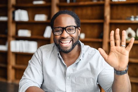 Headshot Of Happy African American Guy Waving Hello Stock Photo Image