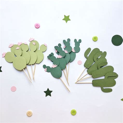 Three Cactus Cupcake Toppers With Green And Pink Decorations