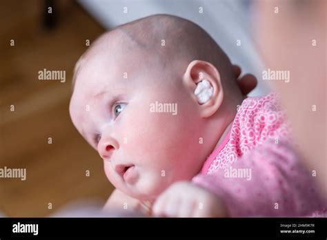 Caucasian Baby With Medication In Ear Infection Treatment Stock Photo