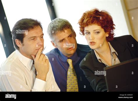 Business Executives Interacting Around Computer Stock Photo Alamy