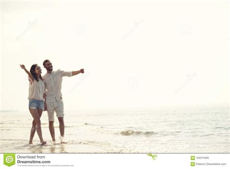 happy fun beach vacations couple walking together laughing having fun on travel destination