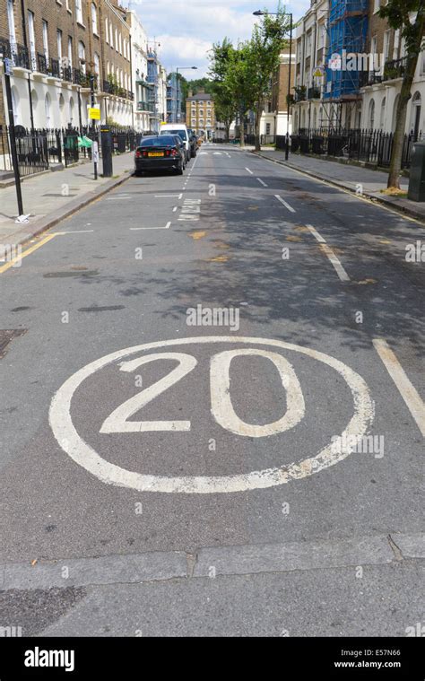 20 Mph Speed Restriction Sign Painted On Road Kings Cross London Stock