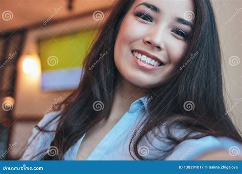 Beautiful Charming Brunette Smiling Asian Girl Taking Selfie On Frontal Camera At Cafe Stock