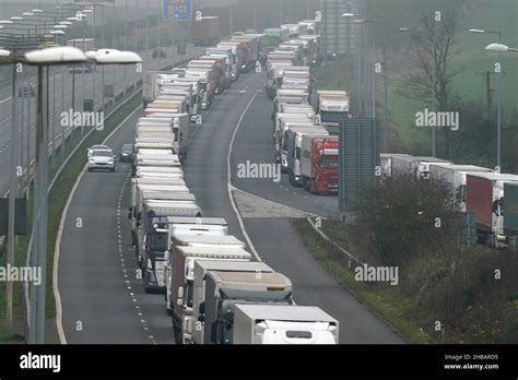 Freight Lorries Queuing On The M20 Motorway In Kent Heading To Dover Left And At The Entrance
