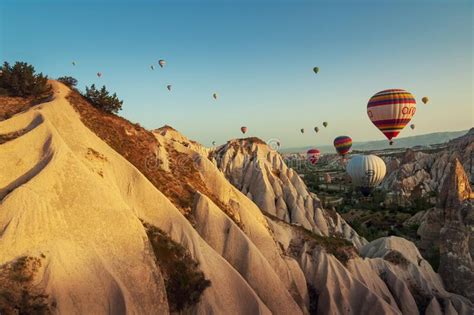 Hot Air Balloon Flying Over Rock Landscape At Cappadocia Turkey At The