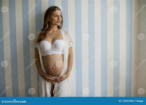 Pregnant Woman Wearing Lingerie And Posing In The Room Stock Photo Image Of Expecting