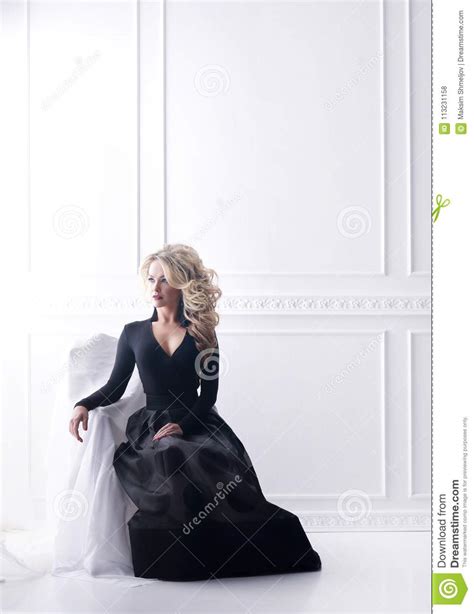 Beautiful Blond Woman Posing In A Black Dress Girl