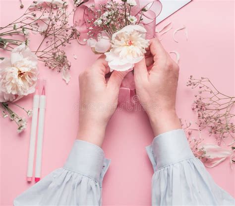 Female Hands Making Floral Arrangements With White Flowers At Pastel