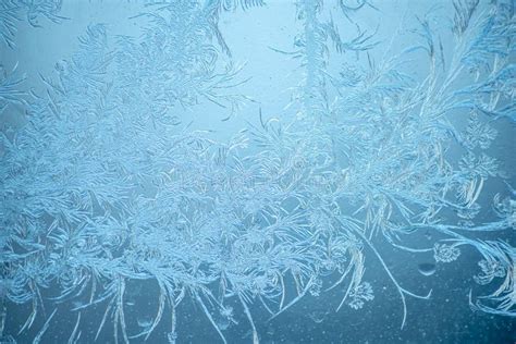 Beautiful Sparkling Natural Frost Pattern On The Blue Window Glass