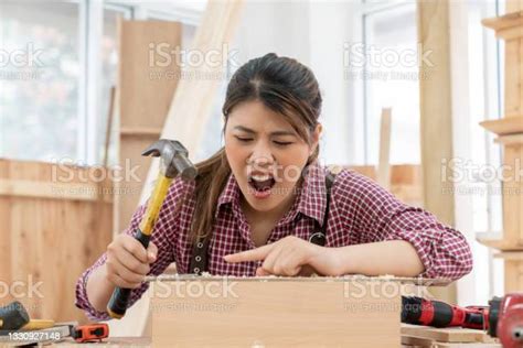 Injuries And Accidents On Female Carpenter Uses A Hammer To Hammering