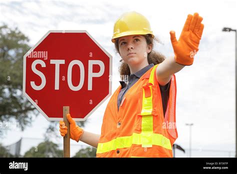 A Female Construction Worker Holding A Stop Sign Stock Photo Alamy