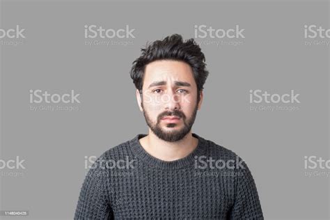 Portrait Of Sad Young Man Looking At Camera With Frustrated Facial