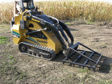 They use attachments such as low profile buckets for hauling or back dragging dirt, or a skid steer blue diamond land leveler attachment for agitating and smoothing out dirt before seeding a lawn. The Rake Landscaping Skid Steer Attachment - Daniel Mfg. Inc.