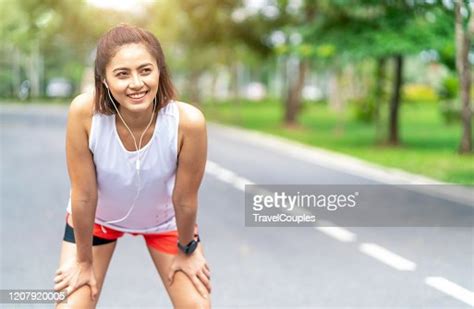 Tired Woman Runner Taking A Rest After Running Hard In The Park