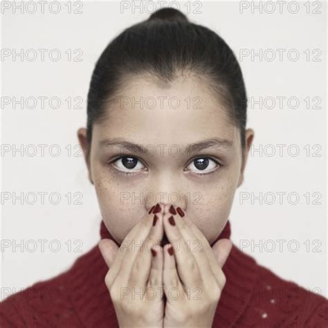 Caucasian Girl Covering Mouth With Hands Photo12 Tetra Images Vladimir Serov