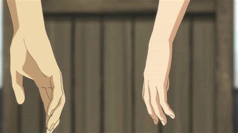 Two Hands Reaching Out Towards Each Other In Front Of A Fence And