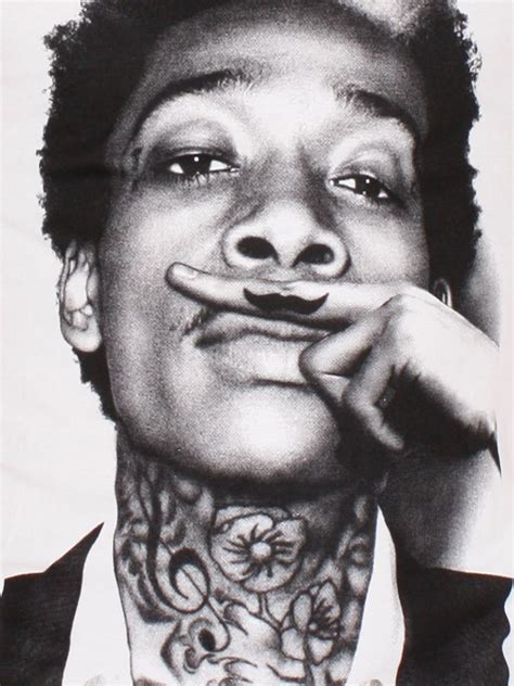 Wiz khalifa, microphone, angel & devil, two skulls, native indian skull, marijuana leaf and peachie are inked on his arms. Wiz Khalifa & his neck #tattoo | Heykel