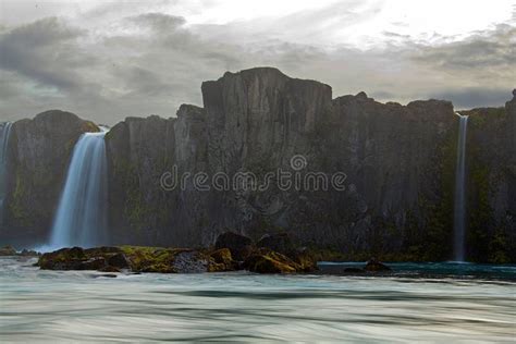 Scenic Long Exposure Shot Of The Waterfalls Falling Down The Cliff In