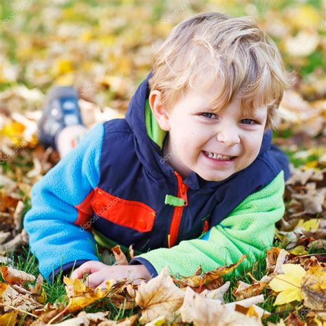 Cute Little Toddler Child Having Fun With Autumn Foliage Stock Photo By