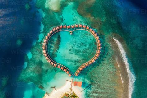 aerial view of a beautiful luxury resort at sunset on alifu dhaalu atoll in north central