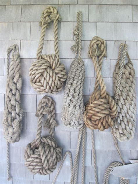 Several Ropes Are Hanging On The Wall Next To Each Other With One Knot