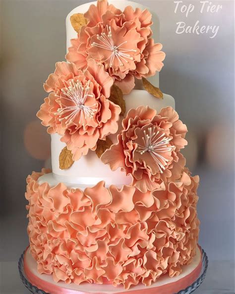 Peach And Gold Wedding Cake With Ruffles And Peonies In