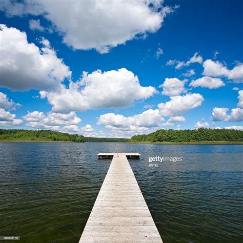 Boardwalk Dock On Lake Under Cloudy Summer Sky High Res Stock Photo