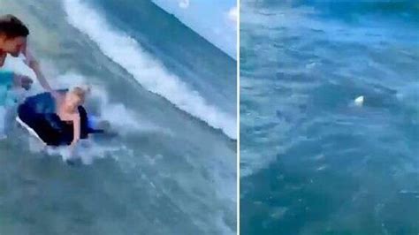 Cop Jumps Into Water Pulls Boy Away From Shark കടലിലേക്ക് ചാടി സ്രാവില്