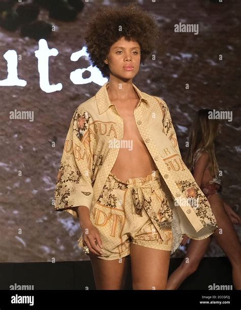A Model Walks The Runway Wearing A Swimsuit By Agua Bendita Fashions